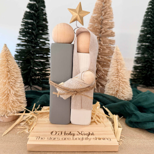 Rustic wooden Nativity set with engraved O Holy Night base and neutral Christmas décor