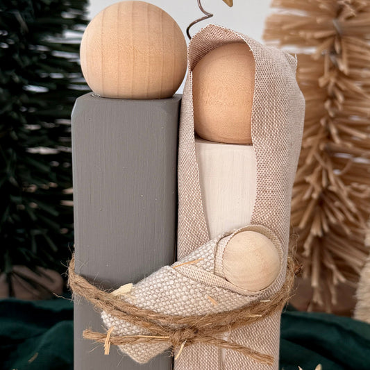 Close-up of Mary and Baby Jesus wrapped in natural fabric and jute twine
