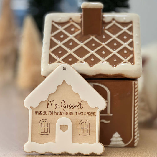 Personalized gingerbread house teacher ornament displayed in front of gingerbread décor