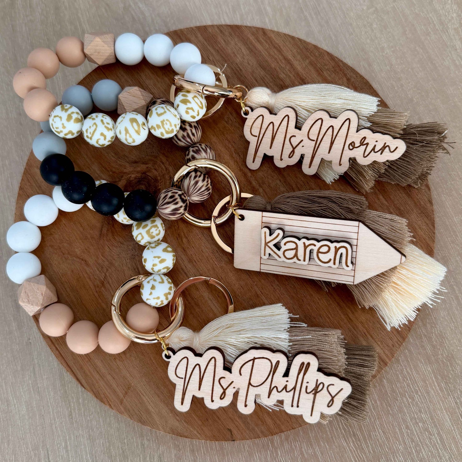 Pastel Bloom and Mocha Feather wristlets shown together with Script and Pencil name tags.